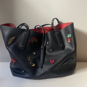 Large and tote bag from Coach. Black leather with red leather interior.